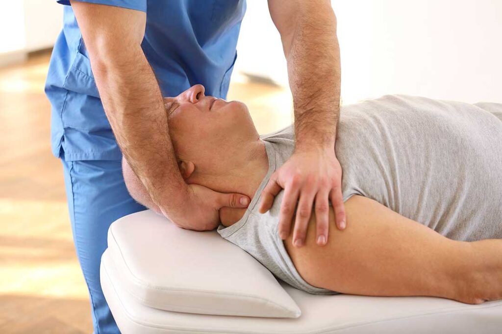 Senior man and woman receiving gentle chiropractic adjustments in a bright, professional clinic setting.